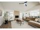 Inviting living room featuring a fireplace, vaulted ceilings, neutral decor, and access to the backyard at 8757 Beluga Way, Las Vegas, NV 89117
