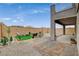 Well-kept backyard features gravel, stone pavers, desert landscaping and a small outdoor seating area with artificial turf at 8801 Trotternish Ridge Dr, Las Vegas, NV 89166