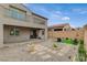 Exterior view of the backyard with stone pavers, gravel, artificial turf and covered patio at 8801 Trotternish Ridge Dr, Las Vegas, NV 89166