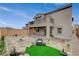 Gravel backyard, stone pavers and artificial turf, with balcony overlooking the space at 8801 Trotternish Ridge Dr, Las Vegas, NV 89166
