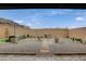 Landscaped backyard featuring decorative gravel, pavers, plants, and a cozy seating area, perfect for relaxation at 8801 Trotternish Ridge Dr, Las Vegas, NV 89166