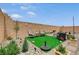 Outdoor seating area with desert landscaping, stone pavers and artificial turf at 8801 Trotternish Ridge Dr, Las Vegas, NV 89166