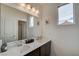 Bright bathroom featuring double sinks, vanity, and framed mirror at 8801 Trotternish Ridge Dr, Las Vegas, NV 89166