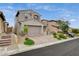 Charming two-story home featuring a neutral color palette, tiled roof, two-car garage, and well-maintained landscaping at 8801 Trotternish Ridge Dr, Las Vegas, NV 89166