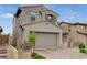 Charming two-story home featuring a neutral color palette, tiled roof, two-car garage, and well-maintained landscaping at 8801 Trotternish Ridge Dr, Las Vegas, NV 89166