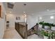 Upstairs hallway with wood banister and decorative plants offers bright, open space at 8801 Trotternish Ridge Dr, Las Vegas, NV 89166