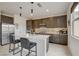 Modern kitchen with stainless steel appliances, center island, pendant lights, and lots of countertop space at 8801 Trotternish Ridge Dr, Las Vegas, NV 89166