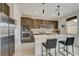 Modern kitchen with stainless steel appliances, center island, pendant lights, and lots of countertop space at 8801 Trotternish Ridge Dr, Las Vegas, NV 89166