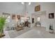 Bright, open-concept living room with high ceilings, tile floors, and stylish decor with neutral-toned furnishings at 8801 Trotternish Ridge Dr, Las Vegas, NV 89166