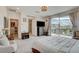 Airy main bedroom with balcony access, plush armchair, and modern entertainment setup at 8801 Trotternish Ridge Dr, Las Vegas, NV 89166