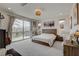 Spacious main bedroom with balcony access, plush carpet, and decorative art pieces at 8801 Trotternish Ridge Dr, Las Vegas, NV 89166
