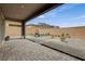 Covered patio overlooks a backyard with stylish landscaping and comfortable seating, extending indoor/outdoor living at 8801 Trotternish Ridge Dr, Las Vegas, NV 89166
