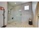 Modern shower with pebble floor, bench, and glass enclosure provides a spa-like experience at 8801 Trotternish Ridge Dr, Las Vegas, NV 89166
