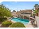 Aerial view of backyard pool and spa, outdoor seating, and lush landscaping at 9404 Low Tide Ct, Las Vegas, NV 89117