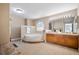 Bathroom with double sink vanity, and a separate bathtub and a step in shower at 9404 Low Tide Ct, Las Vegas, NV 89117