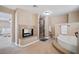 Bathroom with double sink vanity, separate tub and shower, and a fireplace at 9404 Low Tide Ct, Las Vegas, NV 89117
