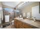 Bright bathroom featuring a double sink vanity, a glass shower, and ample lighting at 9404 Low Tide Ct, Las Vegas, NV 89117