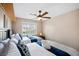 Bright bedroom with two beds, ceiling fan, neutral walls, and natural light at 9404 Low Tide Ct, Las Vegas, NV 89117