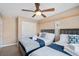 Inviting bedroom with two beds, dark wood frames, and a ceiling fan at 9404 Low Tide Ct, Las Vegas, NV 89117
