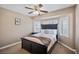 Bedroom with a ceiling fan, a large window with plantation shutters, and a queen-size bed at 9404 Low Tide Ct, Las Vegas, NV 89117