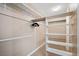 Walk-in closet with shelving and bars for organizing clothes and accessories at 9404 Low Tide Ct, Las Vegas, NV 89117
