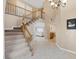 Welcoming foyer featuring staircase with wooden railing and neutral color palette at 9404 Low Tide Ct, Las Vegas, NV 89117