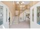 Bright foyer with staircase, tile flooring, and soaring ceilings at 9404 Low Tide Ct, Las Vegas, NV 89117