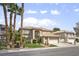 Beautiful two-story home with palm trees and a well-manicured front yard at 9404 Low Tide Ct, Las Vegas, NV 89117