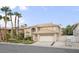 Spacious home with well-manicured front lawn, palm trees, and a two-car garage at 9404 Low Tide Ct, Las Vegas, NV 89117