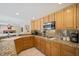 Well-equipped kitchen with granite countertops and wood cabinetry at 9404 Low Tide Ct, Las Vegas, NV 89117