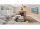 Cozy living room features a brick fireplace, plush sectional, and natural light at 9404 Low Tide Ct, Las Vegas, NV 89117
