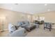 Cozy living room with plush seating and adjacent dining area at 9404 Low Tide Ct, Las Vegas, NV 89117