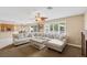 Bright living room showcases a large sectional couch and plantation shutters at 9404 Low Tide Ct, Las Vegas, NV 89117