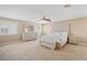 Spacious bedroom features neutral carpet, ceiling fan, plantation shutters and matching dresser, nightstands, and bed at 9404 Low Tide Ct, Las Vegas, NV 89117