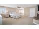 Spacious carpeted primary bedroom with a ceiling fan, a large bed and private ensuite bathroom at 9404 Low Tide Ct, Las Vegas, NV 89117