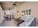 Covered patio with comfortable seating, dining area, and pool view at 9404 Low Tide Ct, Las Vegas, NV 89117