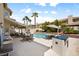 Backyard pool with lush greenery, lounge chairs, and built-in barbecue at 9404 Low Tide Ct, Las Vegas, NV 89117