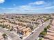 This aerial view captures a sprawling residential neighborhood with mountain views at 9541 Vast Valley Ave, Las Vegas, NV 89148