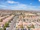Aerial view of a well-planned residential community with neat rows of houses and a distant mountain range on a clear day at 9541 Vast Valley Ave, Las Vegas, NV 89148