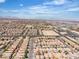 An elevated view captures a vast, orderly suburban area with uniform rooftops stretching to the horizon and distant mountains at 9541 Vast Valley Ave, Las Vegas, NV 89148