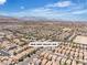 Expansive aerial view of a residential neighborhood with mountain views and clear blue skies at 9541 Vast Valley Ave, Las Vegas, NV 89148