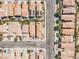 A top-down view reveals a structured residential area, displaying houses aligned along roads and shared green spaces at 9541 Vast Valley Ave, Las Vegas, NV 89148