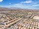 Expansive aerial view of a residential neighborhood with mountain views and clear blue skies at 9541 Vast Valley Ave, Las Vegas, NV 89148