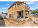 Backyard featuring a covered patio with backyard access and a fire pit with chairs at 9541 Vast Valley Ave, Las Vegas, NV 89148