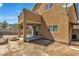 Backyard featuring a covered patio with a fire pit and a view of the home's exterior at 9541 Vast Valley Ave, Las Vegas, NV 89148