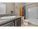 Bathroom showcasing a white sink, dark vanity with granite counter, shower-tub combo and toilet at 9541 Vast Valley Ave, Las Vegas, NV 89148