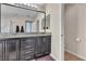 Bathroom featuring a double vanity with granite countertops and tiled floors at 9541 Vast Valley Ave, Las Vegas, NV 89148