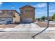 Two-story home featuring an attached two-car garage and low-maintenance landscaping at 9541 Vast Valley Ave, Las Vegas, NV 89148