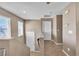 Upstairs hallway with neutral tones, tile floors, and doors leading to various rooms at 9541 Vast Valley Ave, Las Vegas, NV 89148
