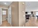 Hallway showing an adjacent door with a bathroom and open view to the living room at 9541 Vast Valley Ave, Las Vegas, NV 89148